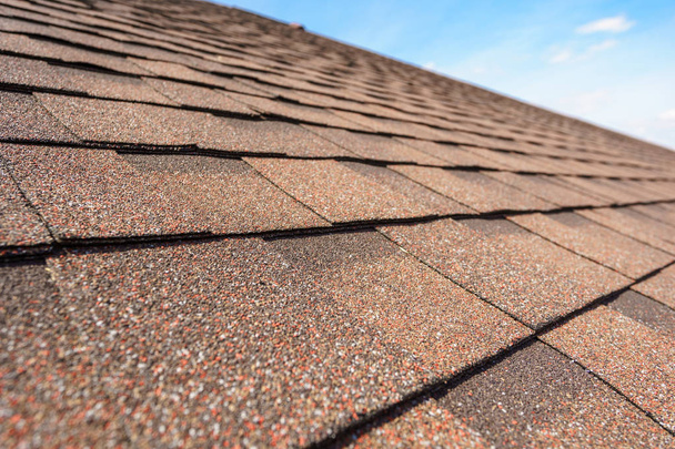 Asphalt tile roof on new home under construction - Photo, Image