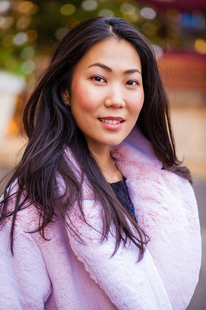 Happy asian woman in winter coat from faux fur - Photo, Image