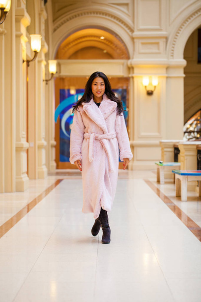 Happy asian woman in winter coat from faux fur - Photo, image