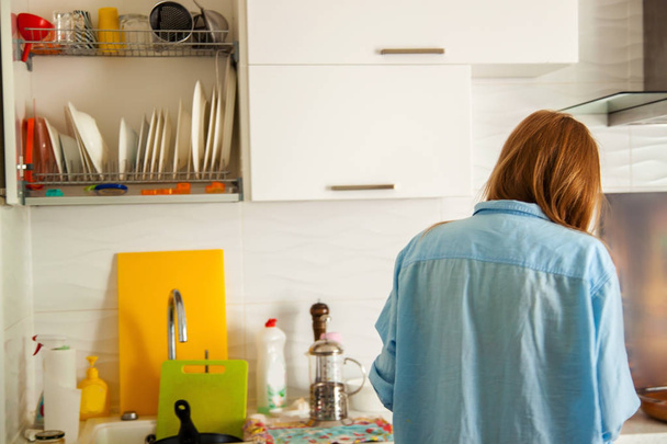 femme femme au foyer lave la vaisselle sale dans la cuisine. - Photo, image