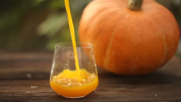 glass of pumpkin juice on  wooden background - Footage, Video
