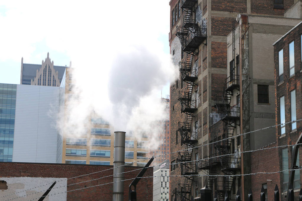 Urban cityscape of fire escapes, barbed wire and pollution.  A grimy city scene.    - Photo, Image