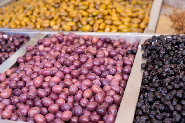 Assortment of olives on market - Фото, изображение