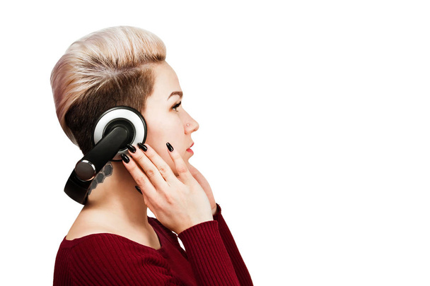 Close-up portrait of beautiful girl with headphones side view. Isolated on white background. - 写真・画像