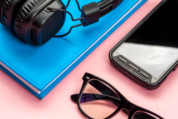 Black stylish headphones on pink background. - Photo, Image