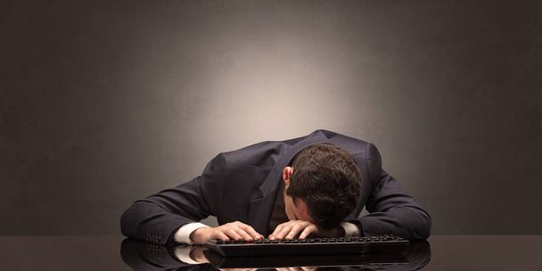 Businessman fell asleep at his workplace - Foto, imagen
