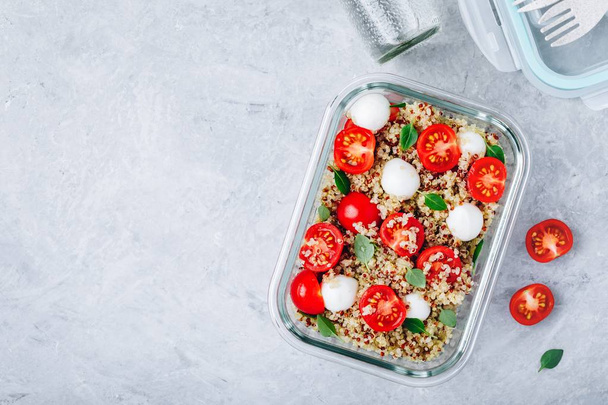 Vegetarische Mahlzeit zubereiten Lunchbox Container mit Quinoa, Mozzarella, Tomaten und Basilikum.  - Foto, Bild