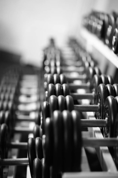 Rows of dumbbells in the gym with hign contrast - Фото, зображення