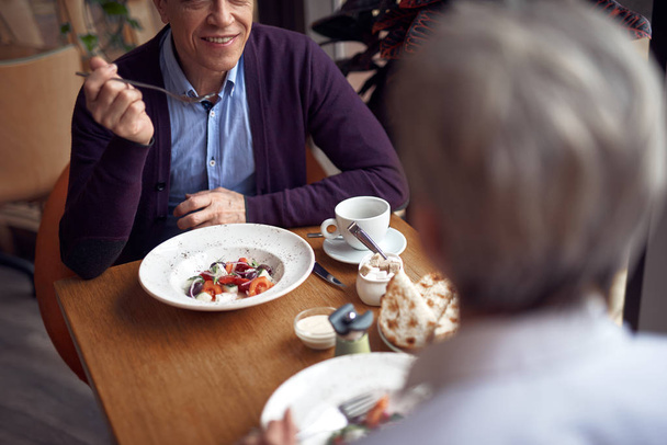 Mature man and woman having dinner in cafe - Fotoğraf, Görsel