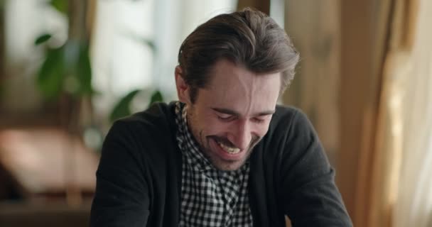 Man laughing while remembering funny memories - Materiał filmowy, wideo