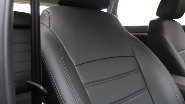 Black leather seat covers in the car. beautiful leather car interior design. stylish leather seats in the car. luxury leather seats in the car. - Footage, Video