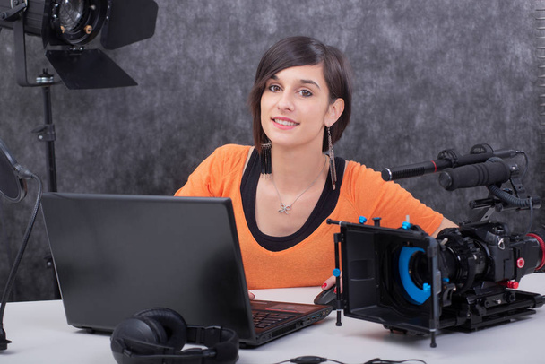 Young woman video editor working in studio - 写真・画像