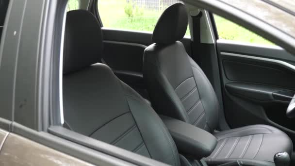 faux leather front seats in the carr. luxury leather seats in the car. Black leather seat covers in the car. beautiful leather car interior design. - Footage, Video