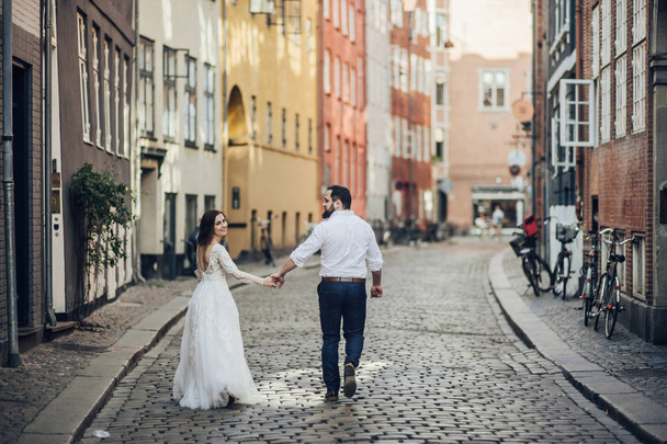 Happy to be together. Lovely wedding tourist couple walking on the city street.  - Foto, imagen