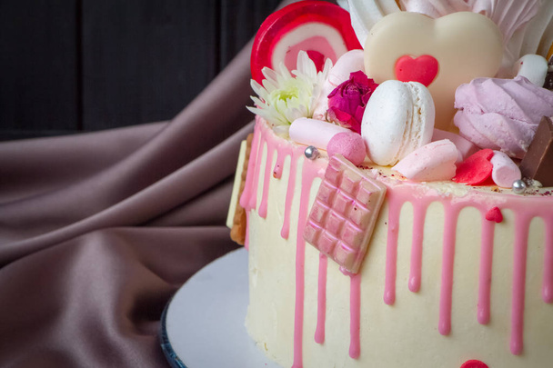 Closeup of black and white chocolate sponge cake with pink and chocolate decoration - 写真・画像