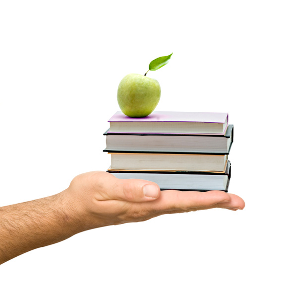 Libros con manzana en la mano como regalo de educación
 - Foto, Imagen