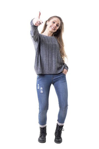 Cute playful young charming woman in gray jumper pointing finger showing you. Full body isolated on white background.  - Photo, Image