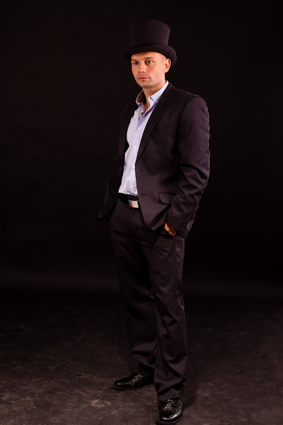 Elegant young man in black suit - Fotoğraf, Görsel