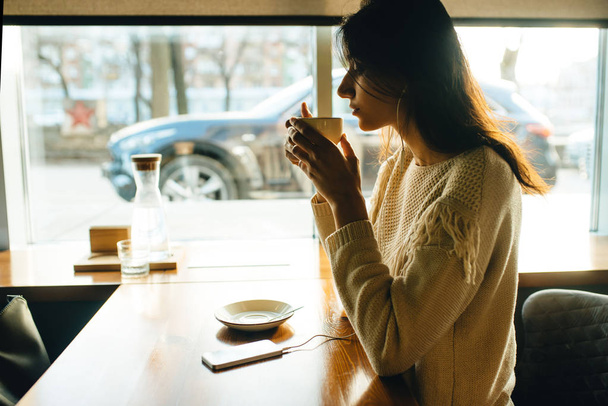 Girl drinking coffee and listening to music - 写真・画像