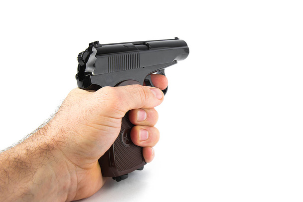 Hand holds a gun isolated on white background - Photo, Image