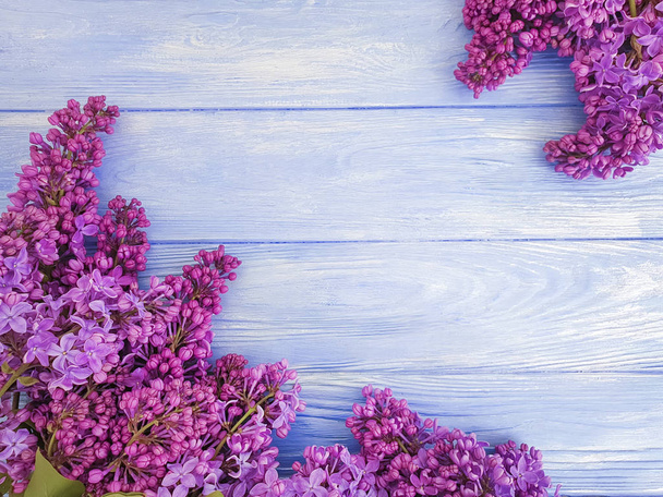 lilac flower bouquet on blue wooden background frame - Photo, Image