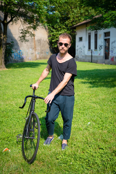 hipster modern stylish blonde man with bike - Photo, Image