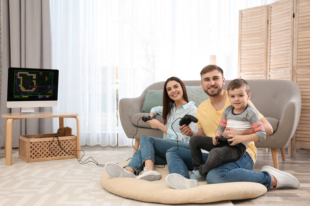 glückliche Familie, die zu Hause Videospiele spielt. Raum für Text - Foto, Bild