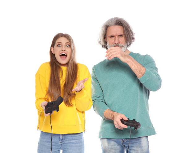Mature man and young woman playing video games with controllers isolated on white - Fotoğraf, Görsel