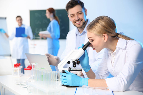 Group of scientists working in modern chemistry laboratory - Photo, image