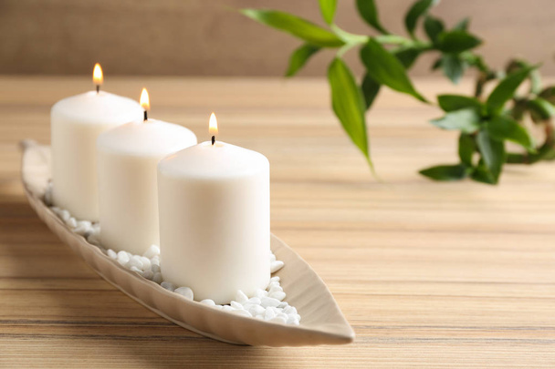 Composition with three candles and bamboo branch on wooden table. Space for text - Fotografie, Obrázek