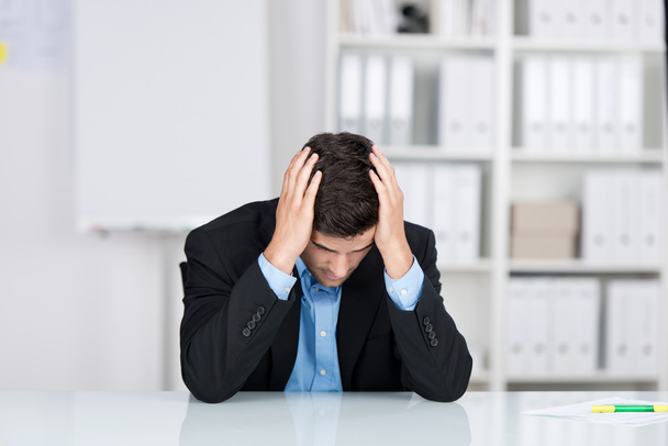 Stressed Businessman With Head In Hands At Desk - Photo, Image
