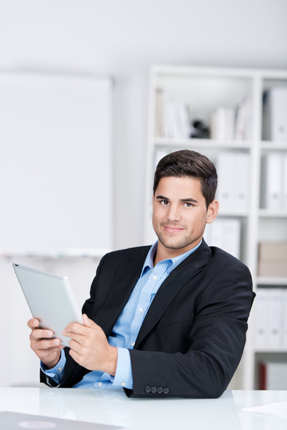 Confident Businessman Holding Digital Tablet At Desk - Фото, зображення