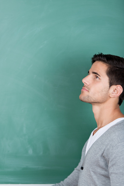 Handsome young student standing thinking - Fotoğraf, Görsel