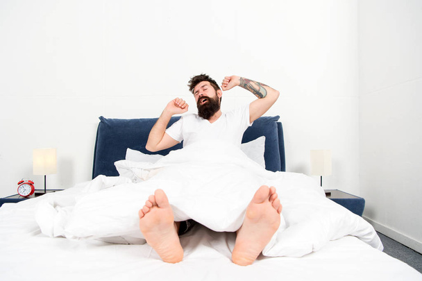 Nice morning. energy and tiredness. brutal sleepy man in bedroom. mature male with beard in pajama on bed. asleep and awake. bearded man hipster sleep in morning. Passed out. Time to wake up - Fotografie, Obrázek