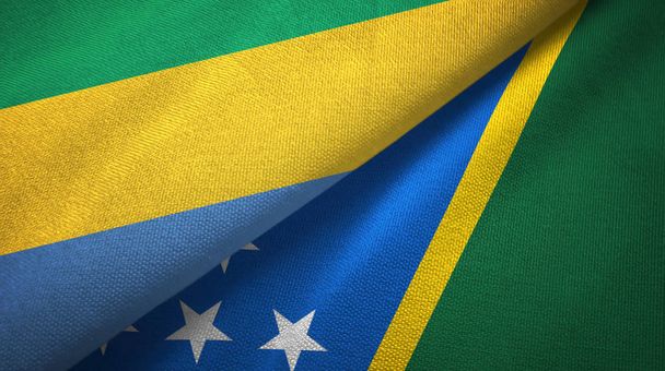 Gabon and Solomon Islands two flags textile cloth, fabric texture - Photo, Image