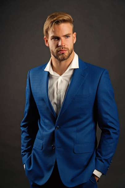 Fashion man in blue suit jacket and shirt. Businessman with bearded face and stylish hair. Manager in fashionable formal outfit. Dress code concept. Business entrepreneurship and career - Zdjęcie, obraz