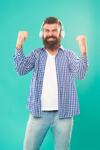 Man in headphones. Streaming music sites hippest and hottest around. Wireless technology. User friendly interface and large library of tunes. Hipster with beard listening music. Handsome music lover - Foto, Imagem