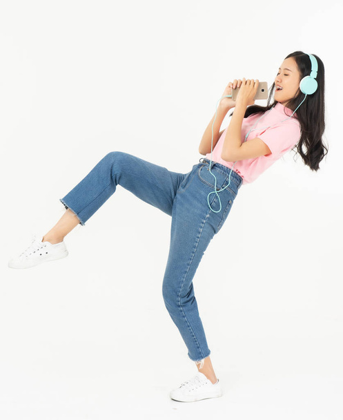 Happy asian teen passenger listening to the music with headphone - Foto, imagen