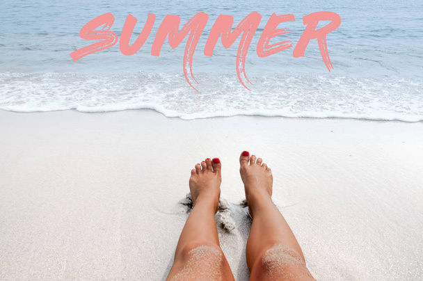 Sea background with lettering summer. Female legs on the beach. - 写真・画像