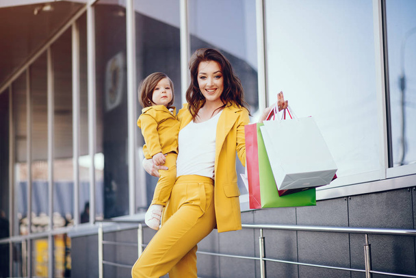 Mother and daughter with shopping bag in a city - Φωτογραφία, εικόνα