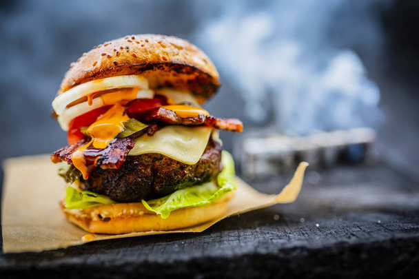 Tasty smoked grilled and glazed beef burger with lettuce, cheese - Photo, Image
