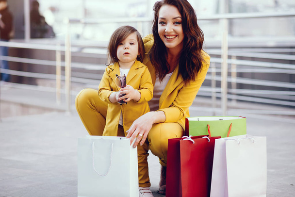 Mother and daughter with shopping bag in a city - Photo, image