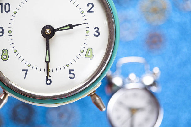 Alarm clock on blue abstract background - Fotografie, Obrázek