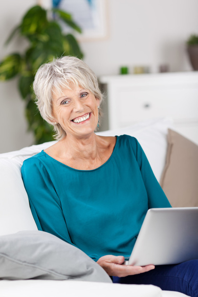 Senior Woman Using Laptop While Sitting On Sofa - Фото, изображение