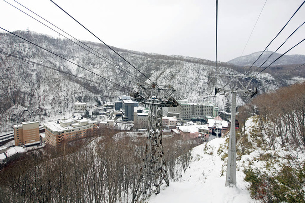 The cable car was climbing to the ropeway station on the summit of Moiwa mountain - Photo, Image