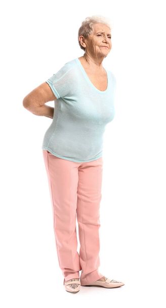 Senior woman suffering from back pain on white background - Photo, Image