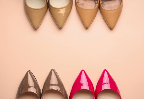 Different stylish high heeled shoes on color background - Fotó, kép