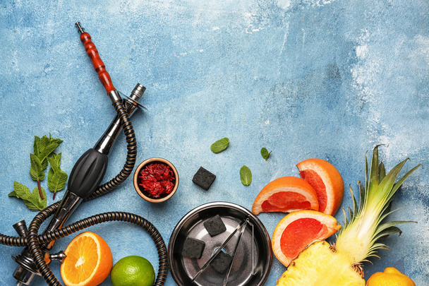 Composition with parts of hookah and fruits on color background - Photo, Image