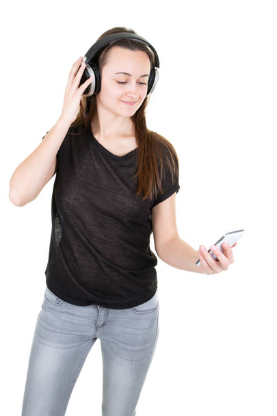 young fit woman with headphones looks at phone - Foto, Imagem