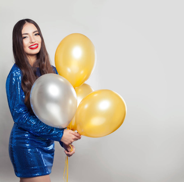 Happy woman in sequins dress with balloons on white background - Fotoğraf, Görsel